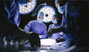 Team of doctors and advanced practice clinicians performing surgery